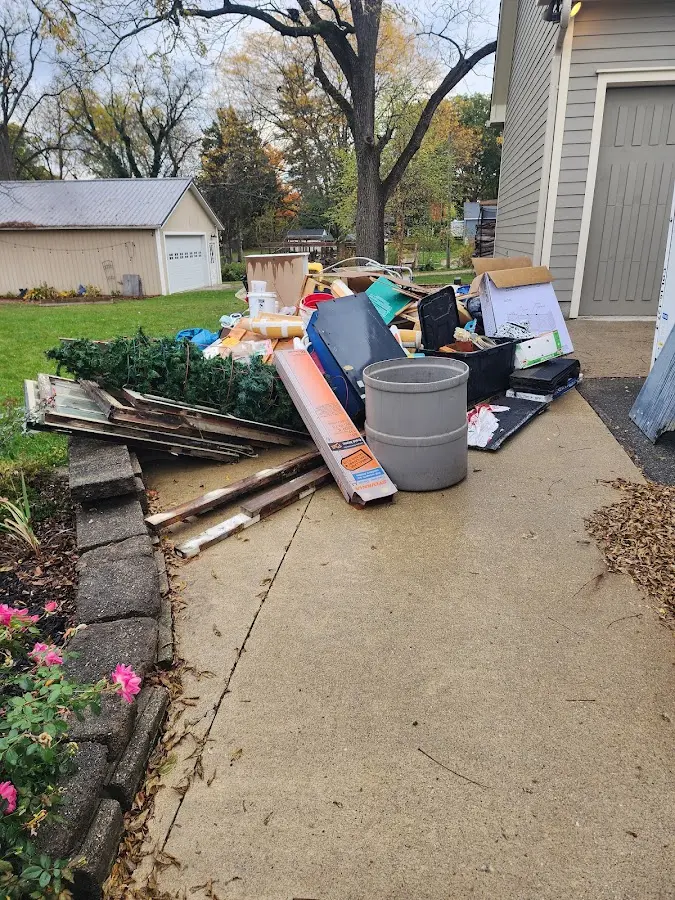 Dumpster being loaded with debris for 12 Yard Dumpster Rental in Dillonvale
